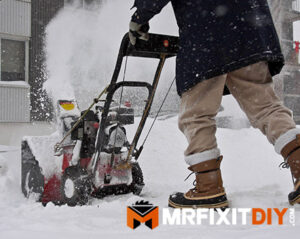 snowblower blowing snow home prepped for winter